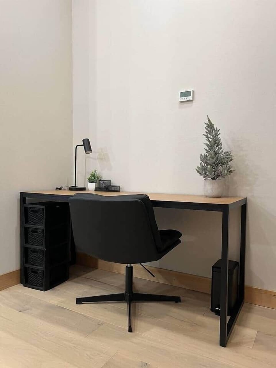 Maintain productivity during your mountain getaway with this sleek, dedicated workspace. This area is designed for the modern professional, featuring a clean wood and matte black desk and a comfortable executive-style swivel chair.