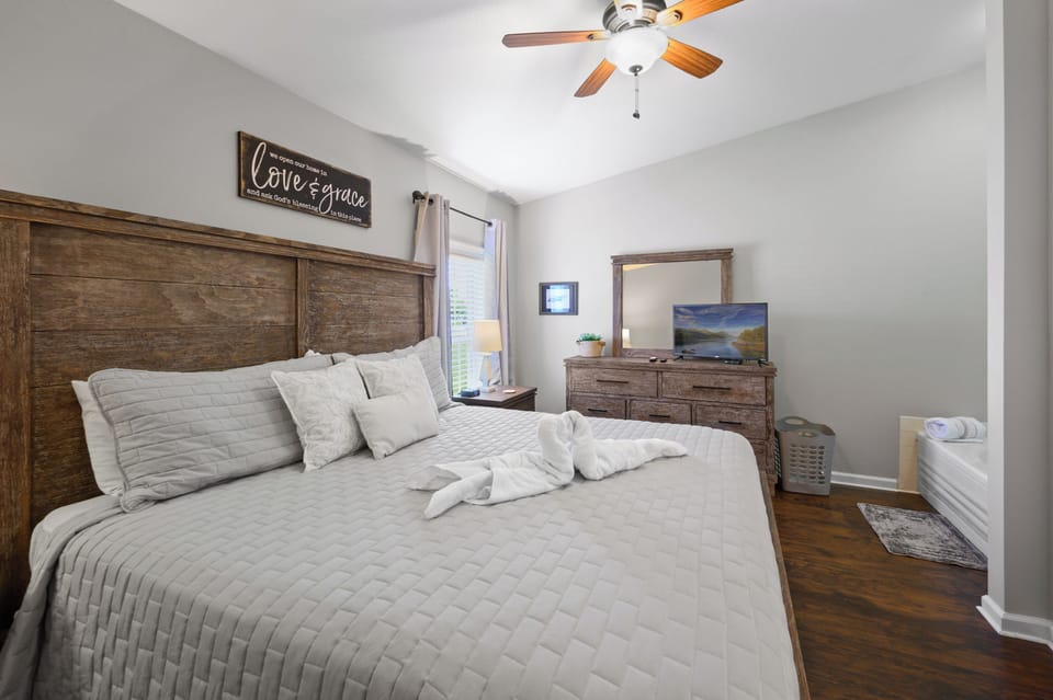King bed in bedroom and jetted jacuzzi tub