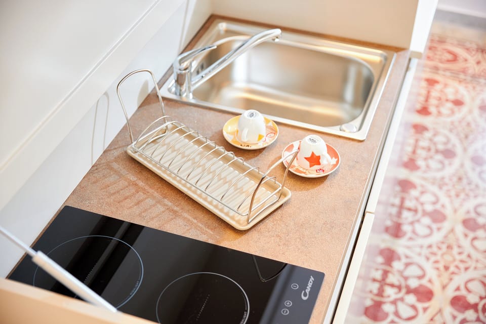 Mini-fridge, stovetop, cookware/dishes/utensils