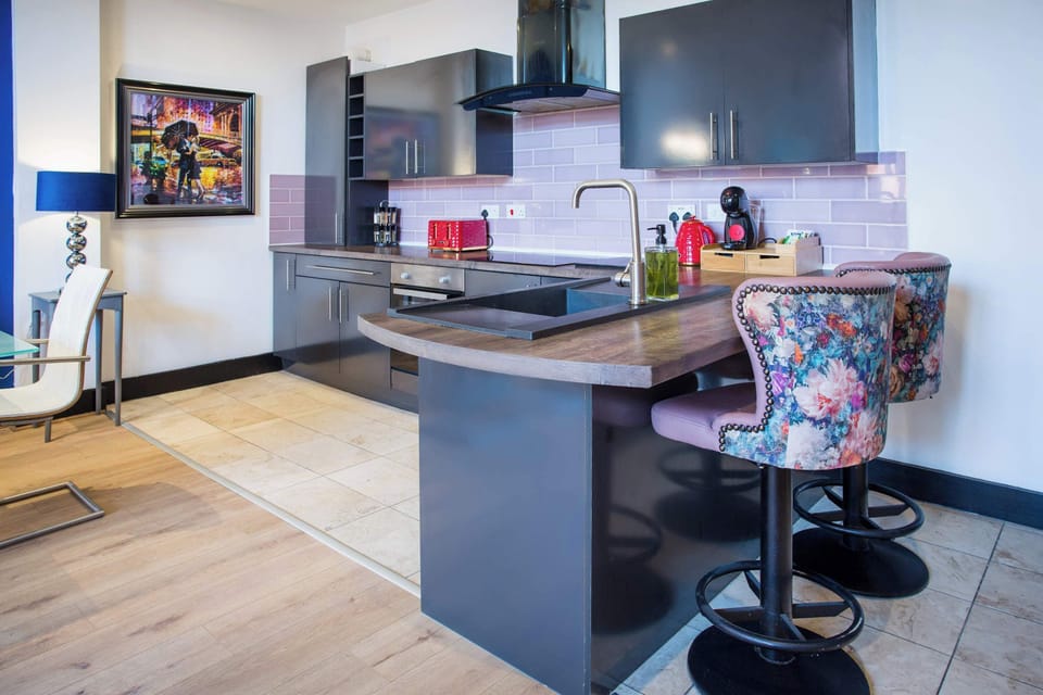 Fully equipped modern kitchen complete with cooking utensils, cookware, crockery and cutlery