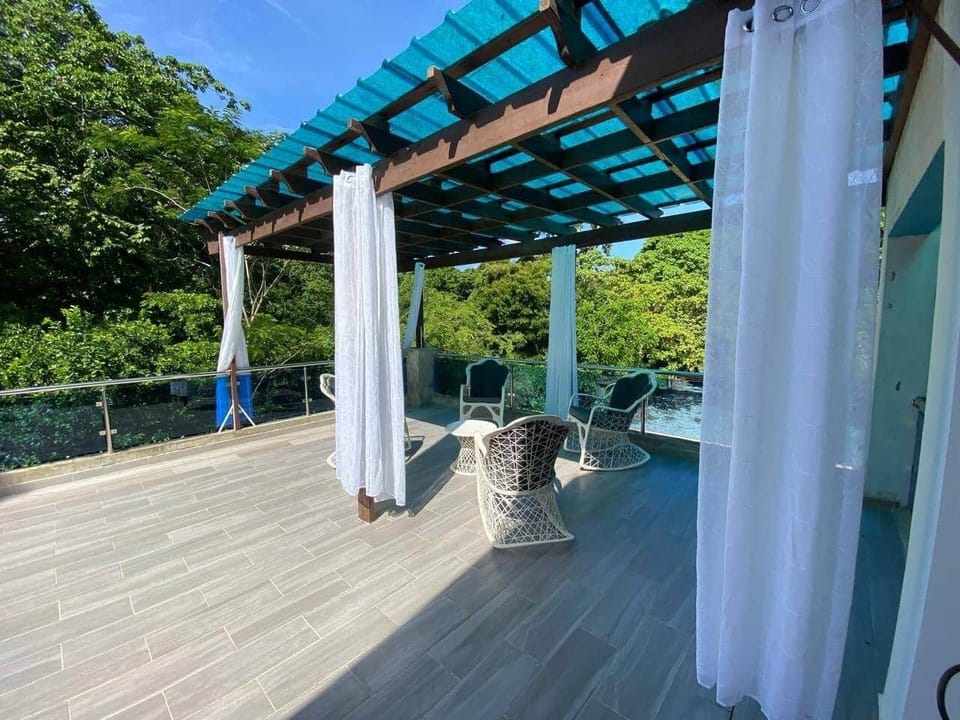 Upper terrace with pergola — perfect for cocktails, and relaxation.