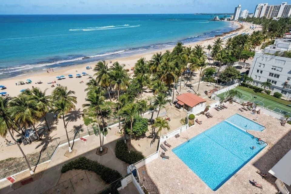 Your resort-style escape! Enjoy direct access to the pristine sandy beach, a sparkling swimming pool, and even a tennis court, all just steps from your door.