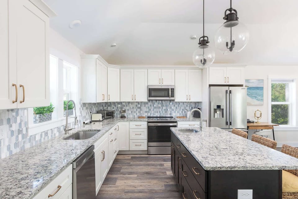 Top Level: Fully Equipped Kitchen with Stainless Steel Appliances and Granite Countertops.