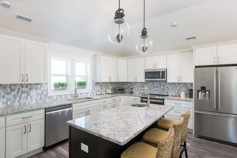 Top Level: Fully Equipped Kitchen with Stainless Steel Appliances and Granite Countertops.