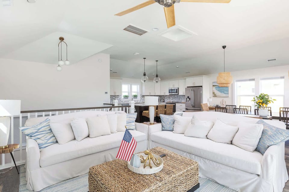 Top Level: Open-Concept Living Area with Smart TV, Cozy Seating, Ceiling Fan, and Deck Access