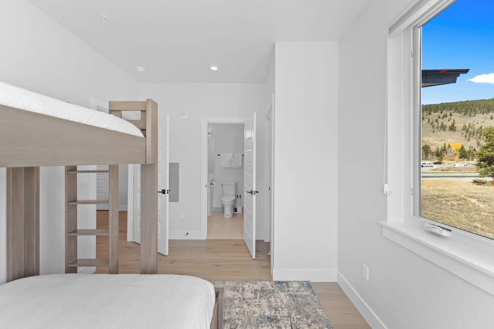 Relax in your bright, modern bedroom with stunning mountain views and a convenient ensuite bathroom at your fingertips.