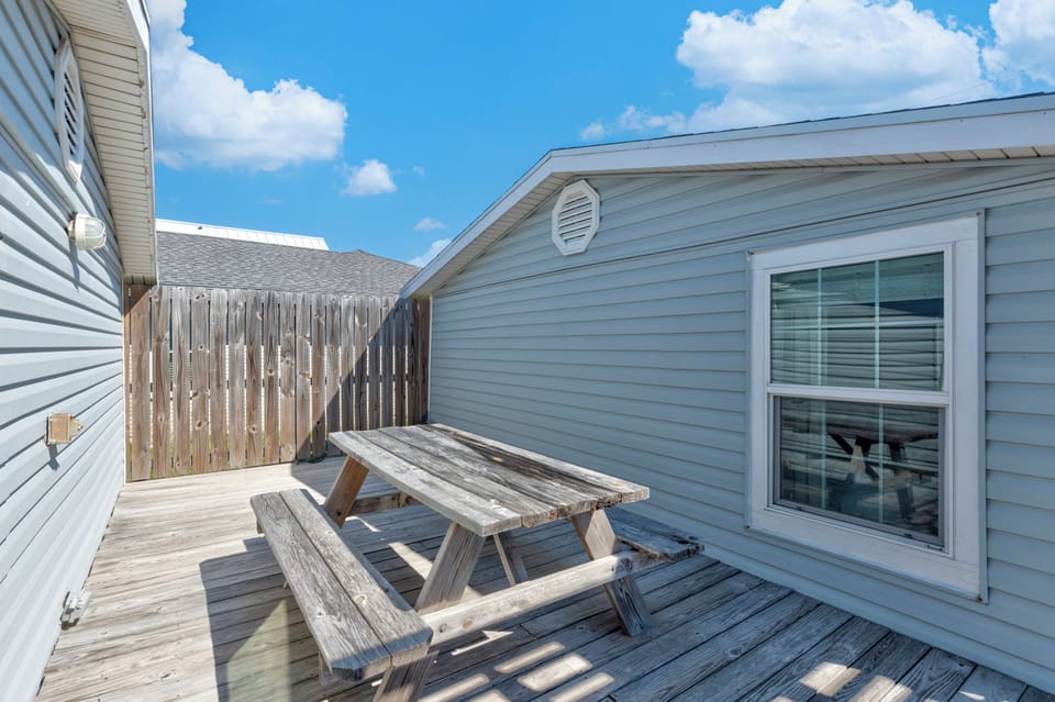 Step onto your private deck where a rustic picnic table awaits your morning coffee or evening meal under the open sky.
