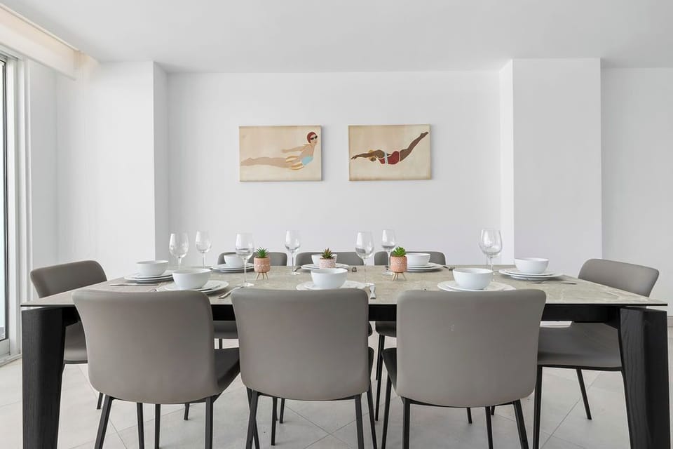 Gather around this elegant dining table where shared meals become treasured memories. Soft natural light fills the space, and tasteful artwork sets a welcoming tone for your group.