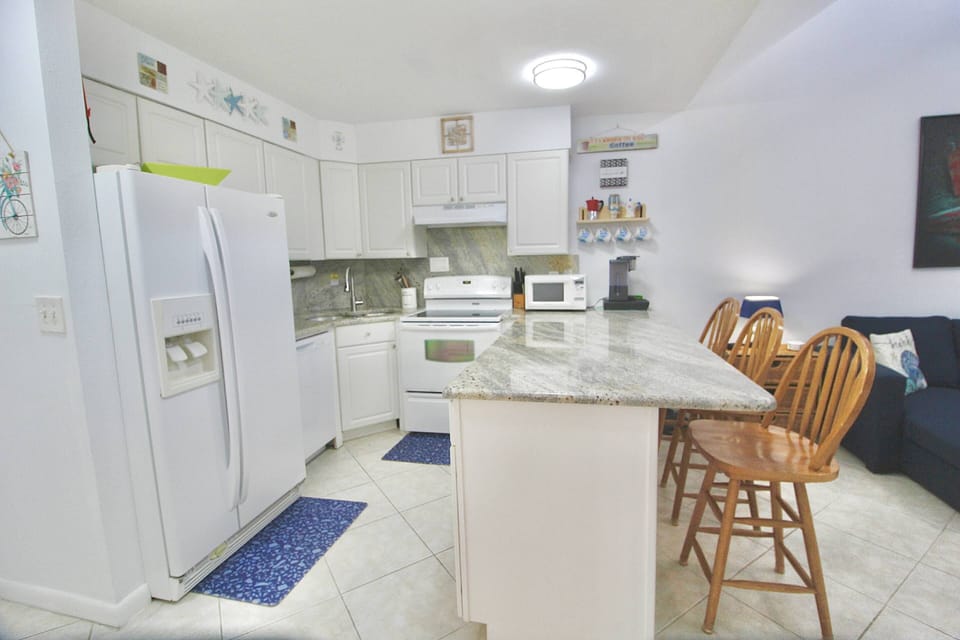 The open kitchen has plenty of space to prep, cook and dine…