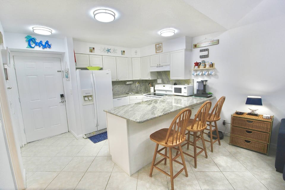 The kitchen boasts beautiful granite counters with island seating for 3.
