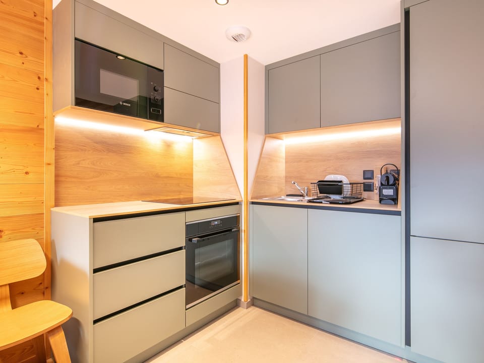 Cook your favorite meals in a sleek, modern kitchenette, equipped with all essentials.