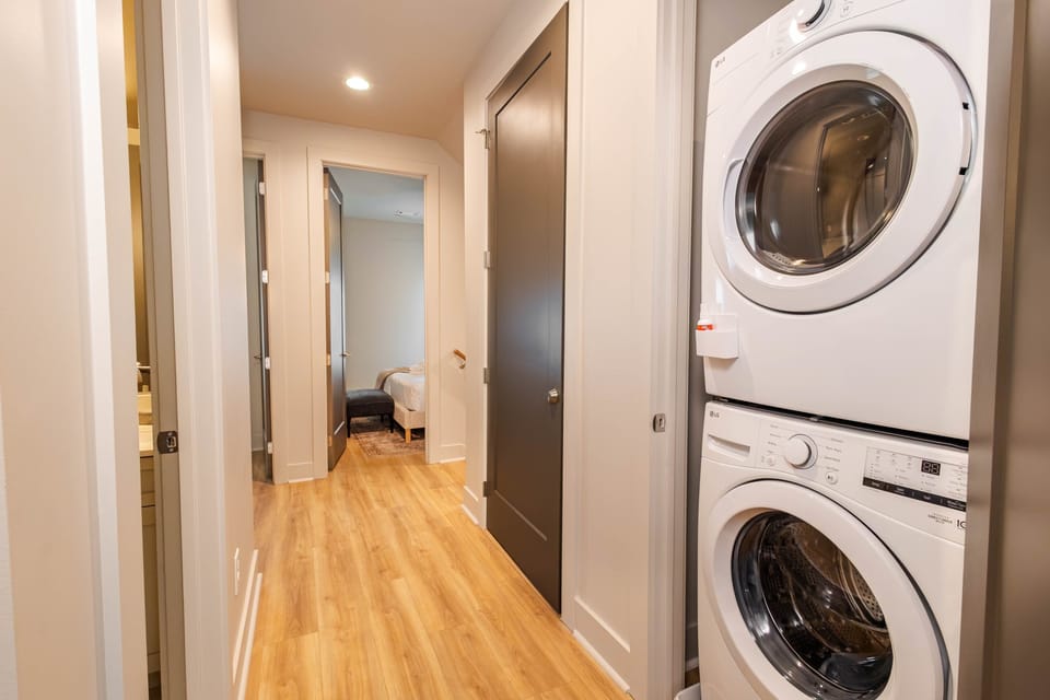 Washer and dryer area with provided tide pin and detergent. Extra pillows and blankets are provided