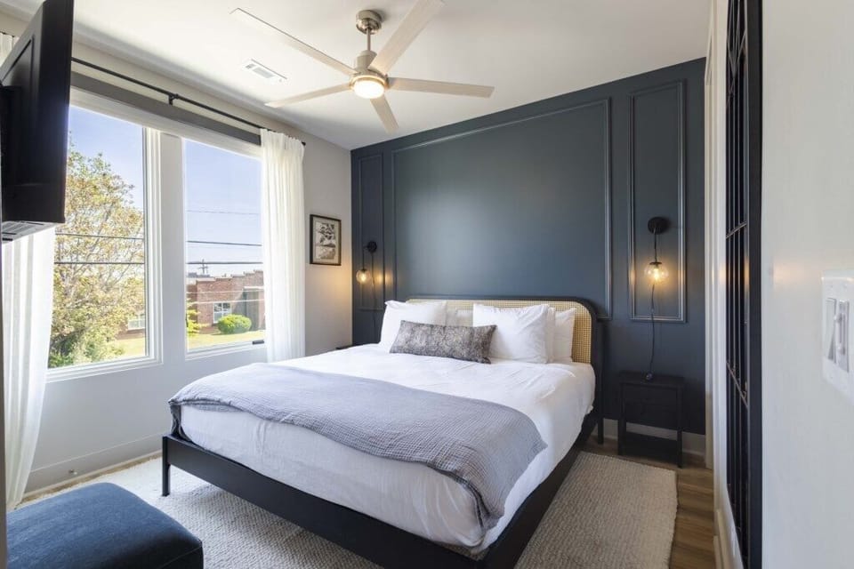 Bedroom 4- Relaxing bedroom with king sized bed, blackout shades, Smart TV, and a plush pillow top mattress cover.