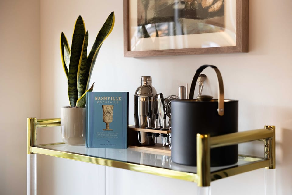 Stylish bar cart featuring a cocktail recipe book, ideal for mixing drinks and setting the tone for your evening