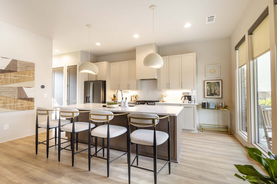 Bright modern kitchen featuring a large island, sleek finishes, and plenty of space to cook, dine, and unwind