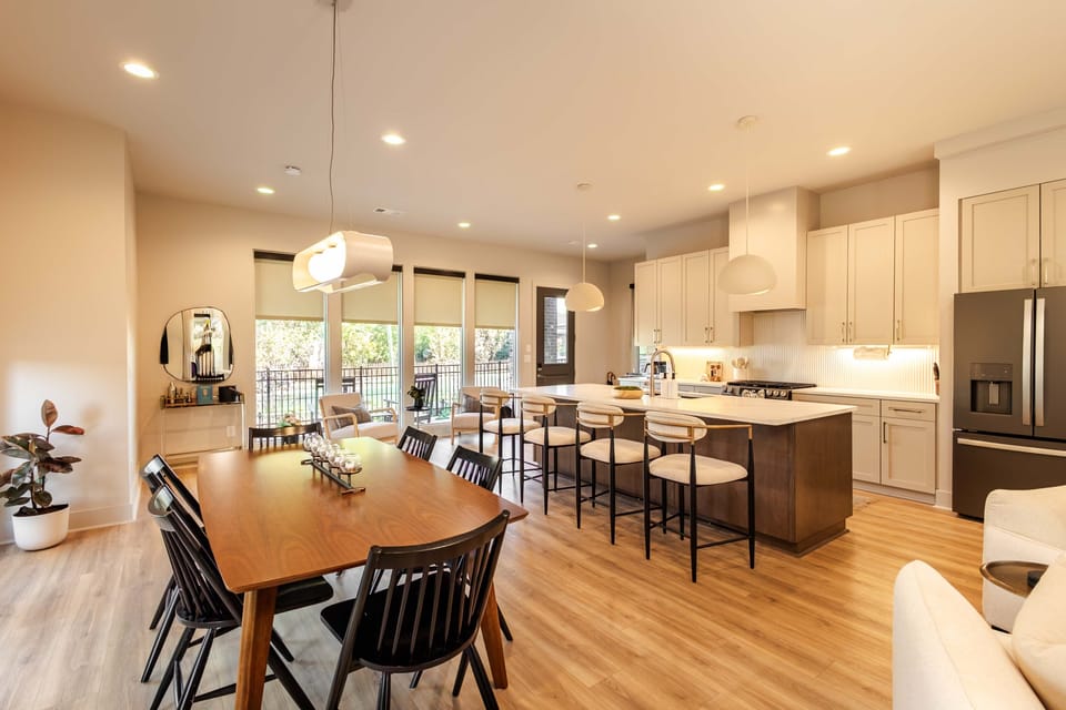 Bright modern kitchen featuring a large island, sleek finishes, and plenty of space to cook, dine, and unwind