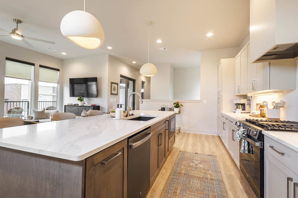 Open kitchen with island seating and seamless flow into living areas