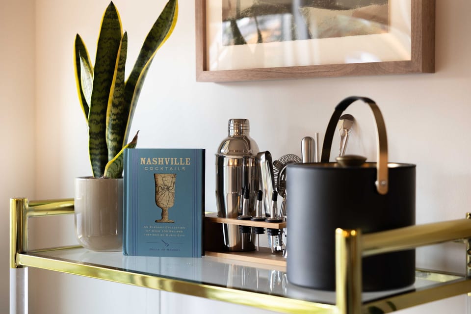 Stylish bar cart featuring a cocktail recipe book, ideal for mixing drinks and setting the tone for your evening.