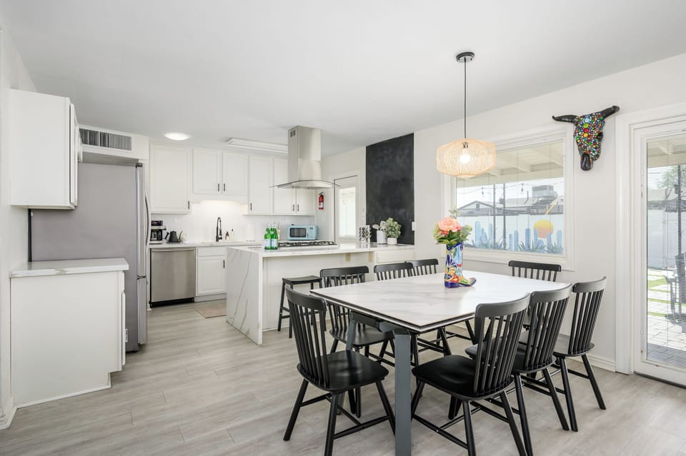 Gather around the table in this bright, modern kitchen that accommodates up to 10 guests. With plenty of seating, sleek finishes, and views of the backyard, it’s the perfect space to cook, connect, and create lasting memories together.