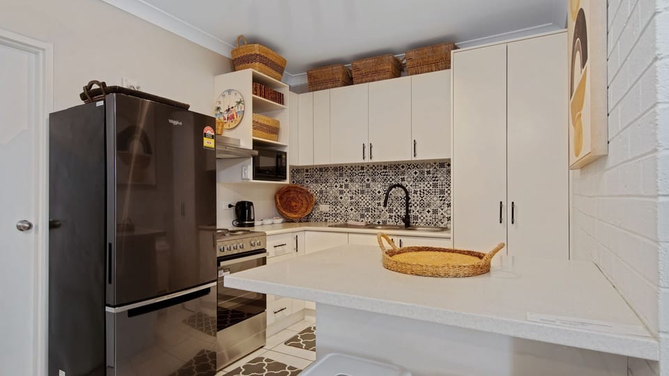 Kitchen featuring full-size refrigerator and ample storage.