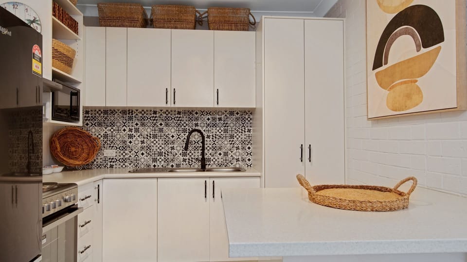 Contemporary kitchen with tiled splashback and modern finishes.