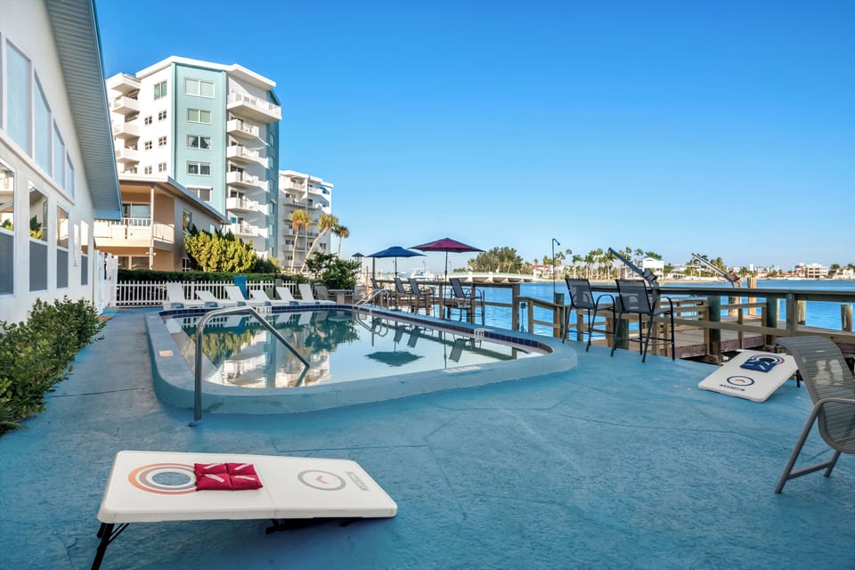 Bay views with pool, cornhole & shaded seating.