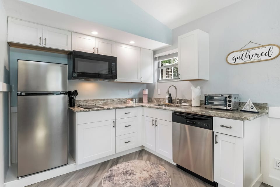 Fully stocked kitchen with stainless appliances—bright, sleek, and ready.