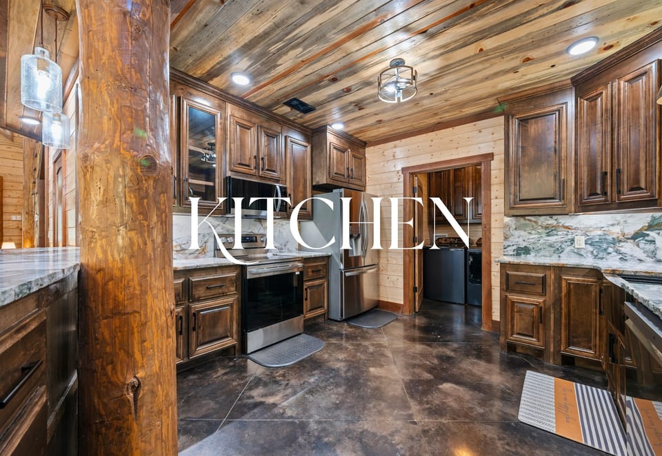 Fully equipped kitchen with stainless appliances and wood cabinetry.