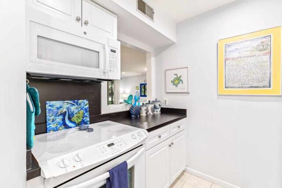 Modern kitchen featuring a unique blue scallop-tile backsplash.