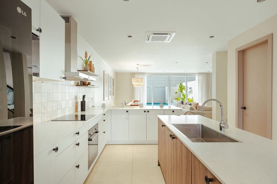 Fully equipped kitchen featuring modern appliances, cookware, essentials, and ample space for meal preparation