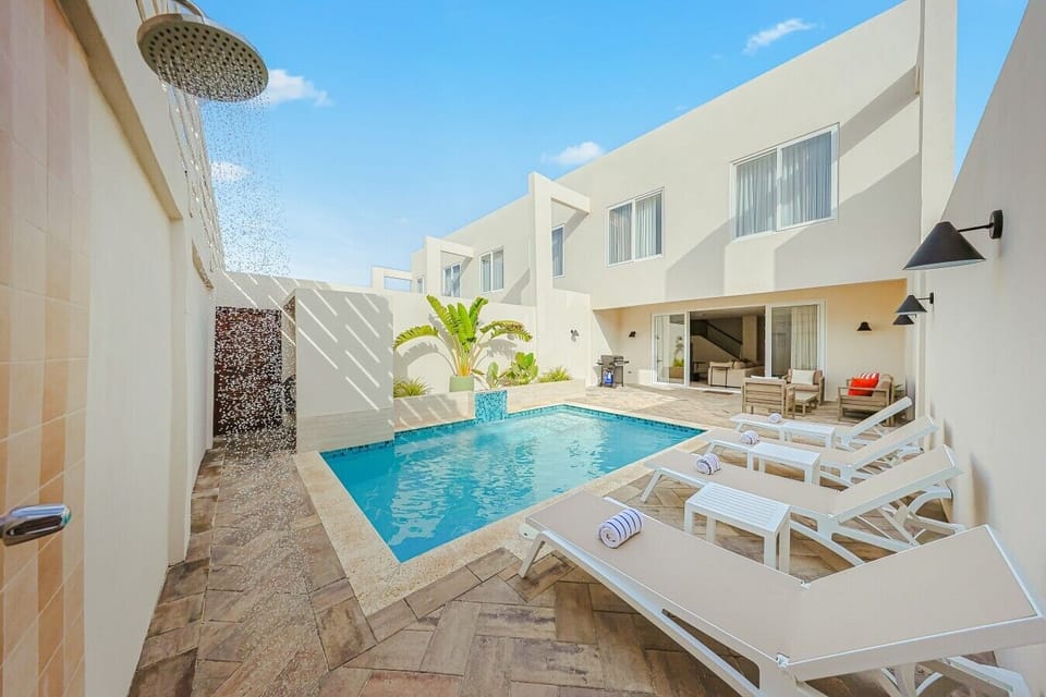 Refreshing outdoor pool perfect for swimming, relaxing, sunbathing, and enjoying tropical weather year-round.