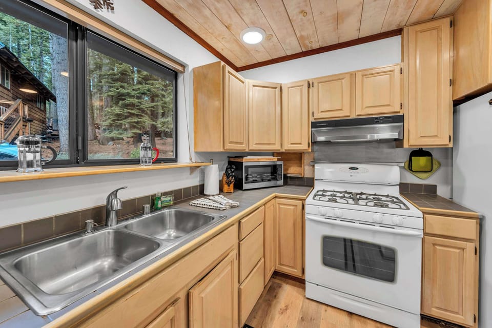 Kitchen: Main floor, drip coffee maker, French press, waffle maker, cooking utensils, tableware