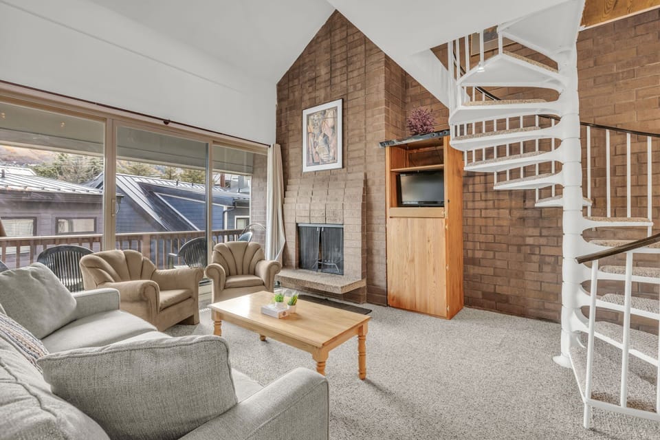 Living room: Main floor, wood-burning fireplace (currently unavailable), Smart TV, patio access