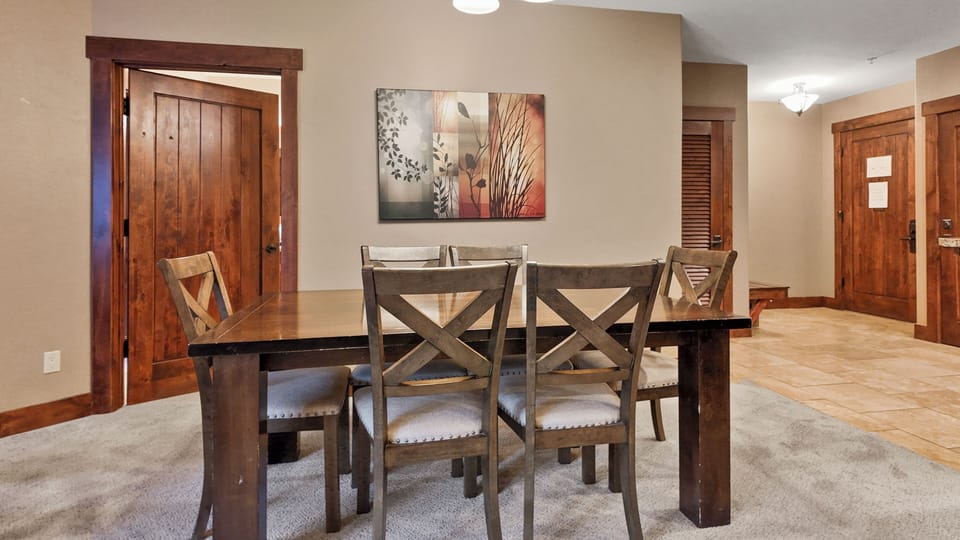 Cozy dining nook with table for four and wall art.
