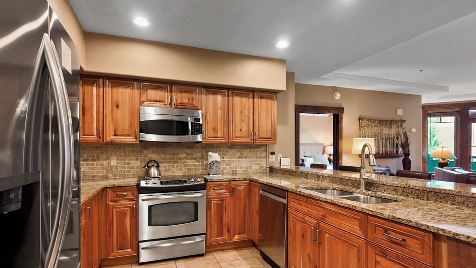 Spacious kitchen with wood cabinetry and modern design.