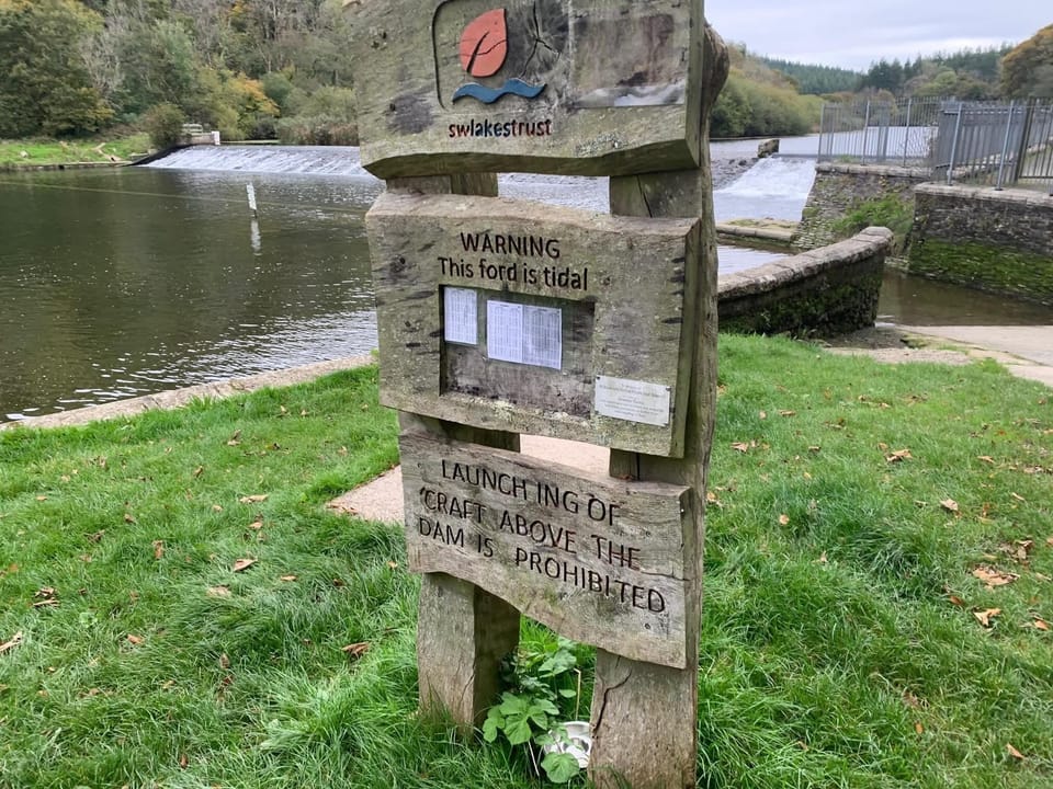 Info board by the property which shows the tide times 