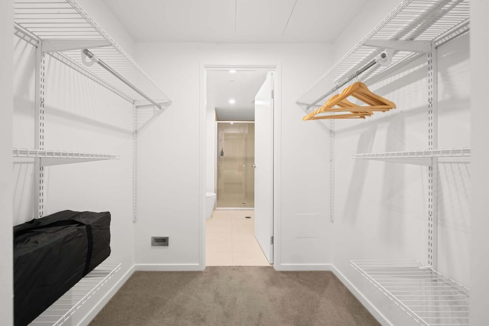 A generous walk-in wardrobe provides ample hanging and shelving, leading through to the private ensuite.