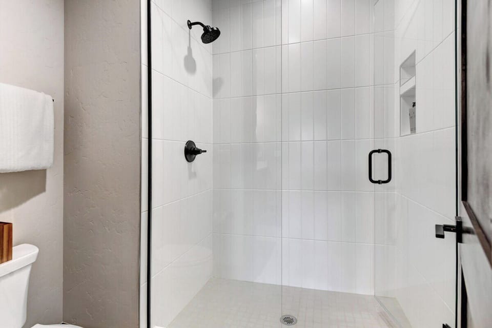 Main level master suite bathroom with double vanity and shower