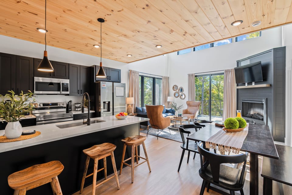 Open-concept area features seamless transitions from living to kitchen area.