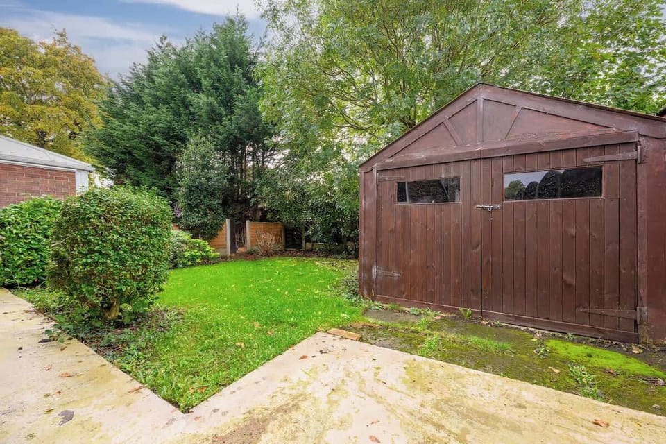 Private enclosed rear garden with lawn and storage shed, a rare bonus for a city stay