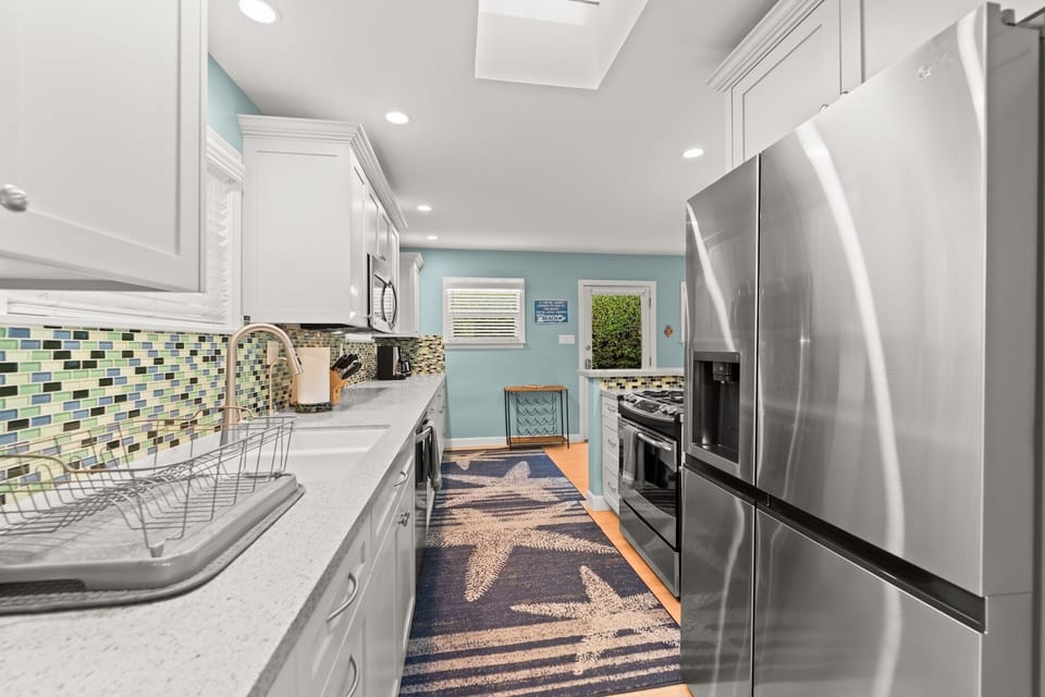 Sleek and shining. This modern kitchen comes fully equipped with stainless steel appliances, ready for your culinary adventures.
