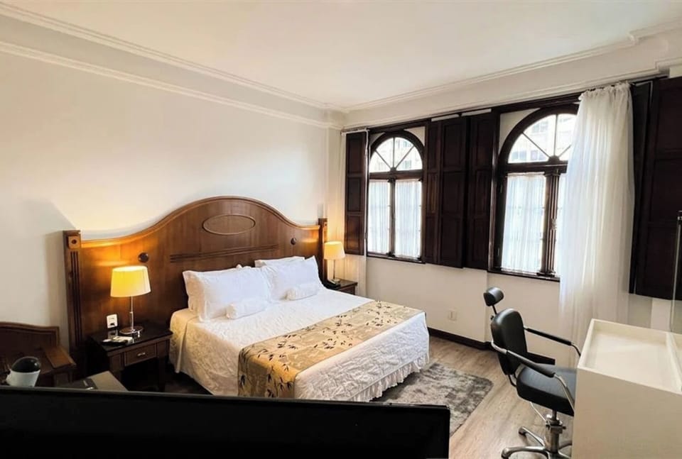 Wake to golden light beside charming arched windows and shutters