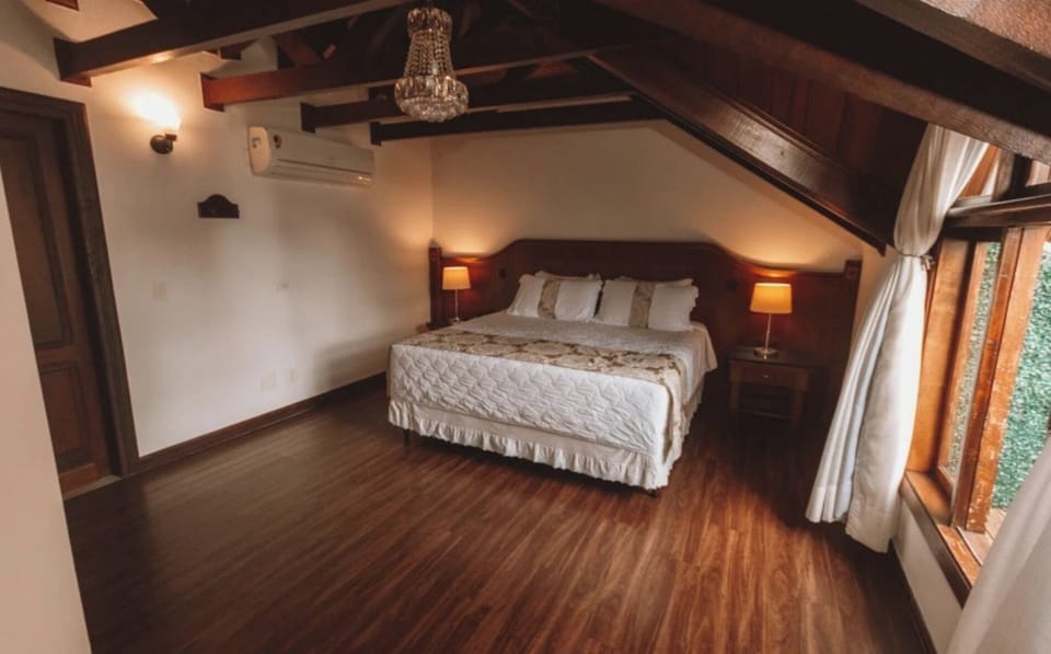Stretch out beneath timber beams in this warm, airy suite.