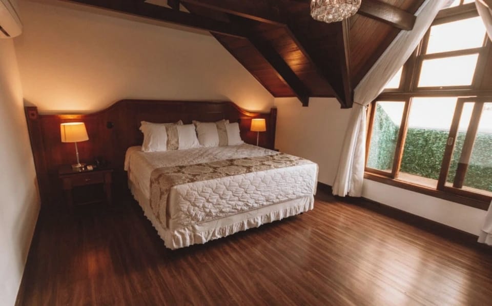 Wake up to sunlit comfort in a serene, spacious bedroom.