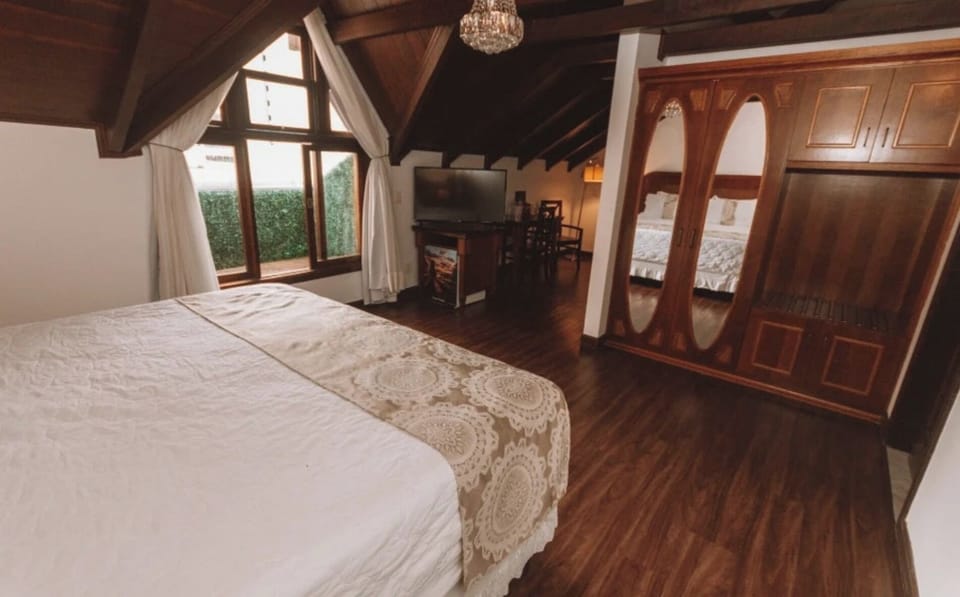 Lounge comfortably with in-room TV, generous space, and warm wood.