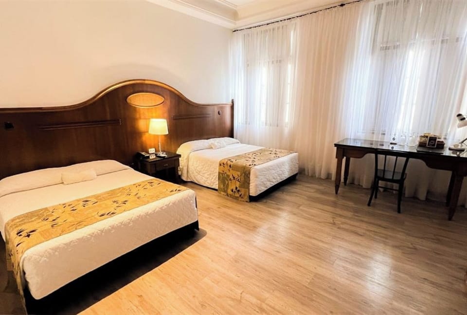 Spread out comfortably in a bright twin room with workspace.