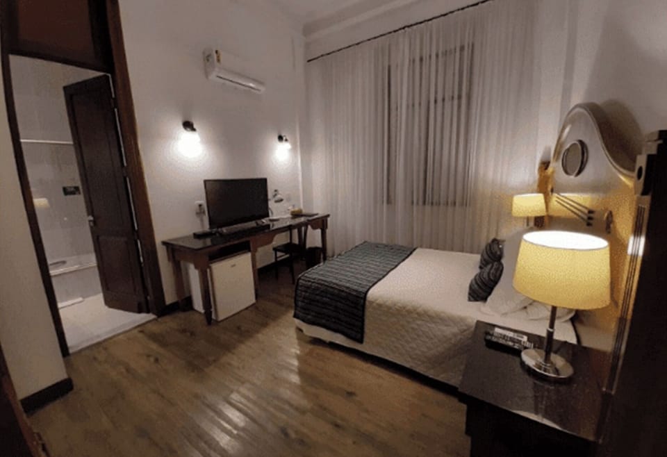 Stretch out in a roomy layout with desk and bedside glow.
