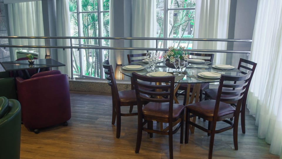 Gather for a leisurely meal by bright, garden-facing windows.