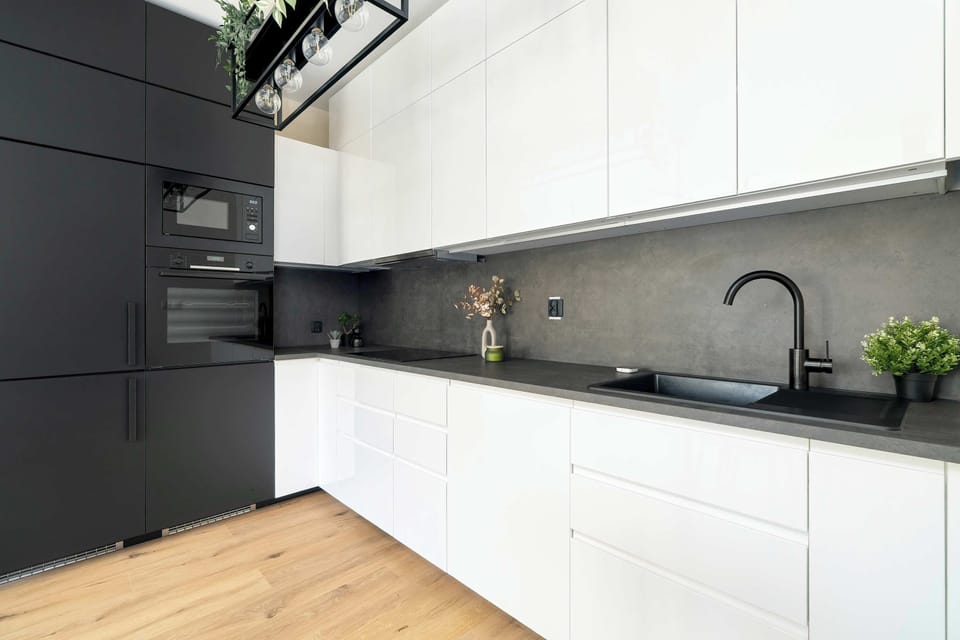 The sleek design of the kitchenette blending seamlessly with the living area.