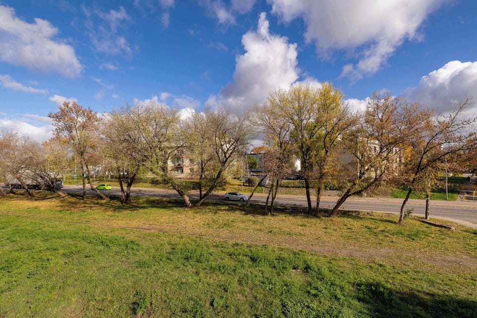 The greenery around the property and the tree-lined path add charm and a sense of connection with nature.